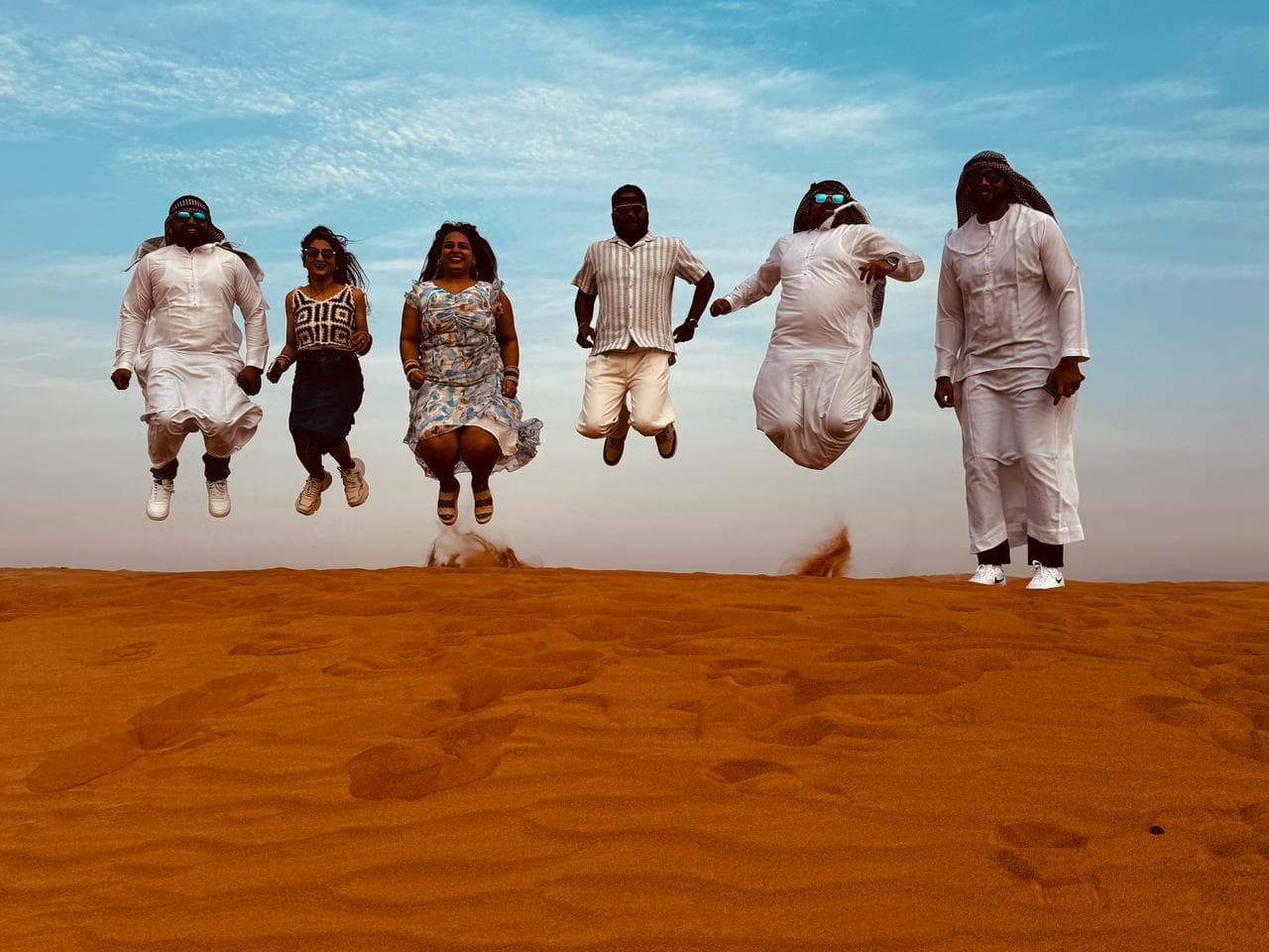 A group jumping together on the dunes