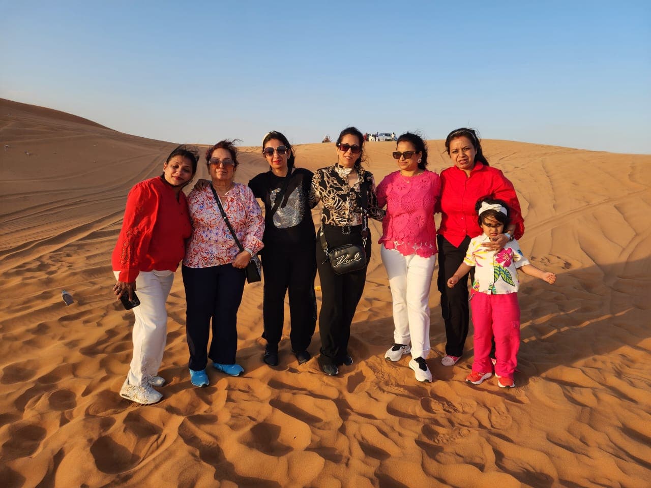 A family group together on a desert safari