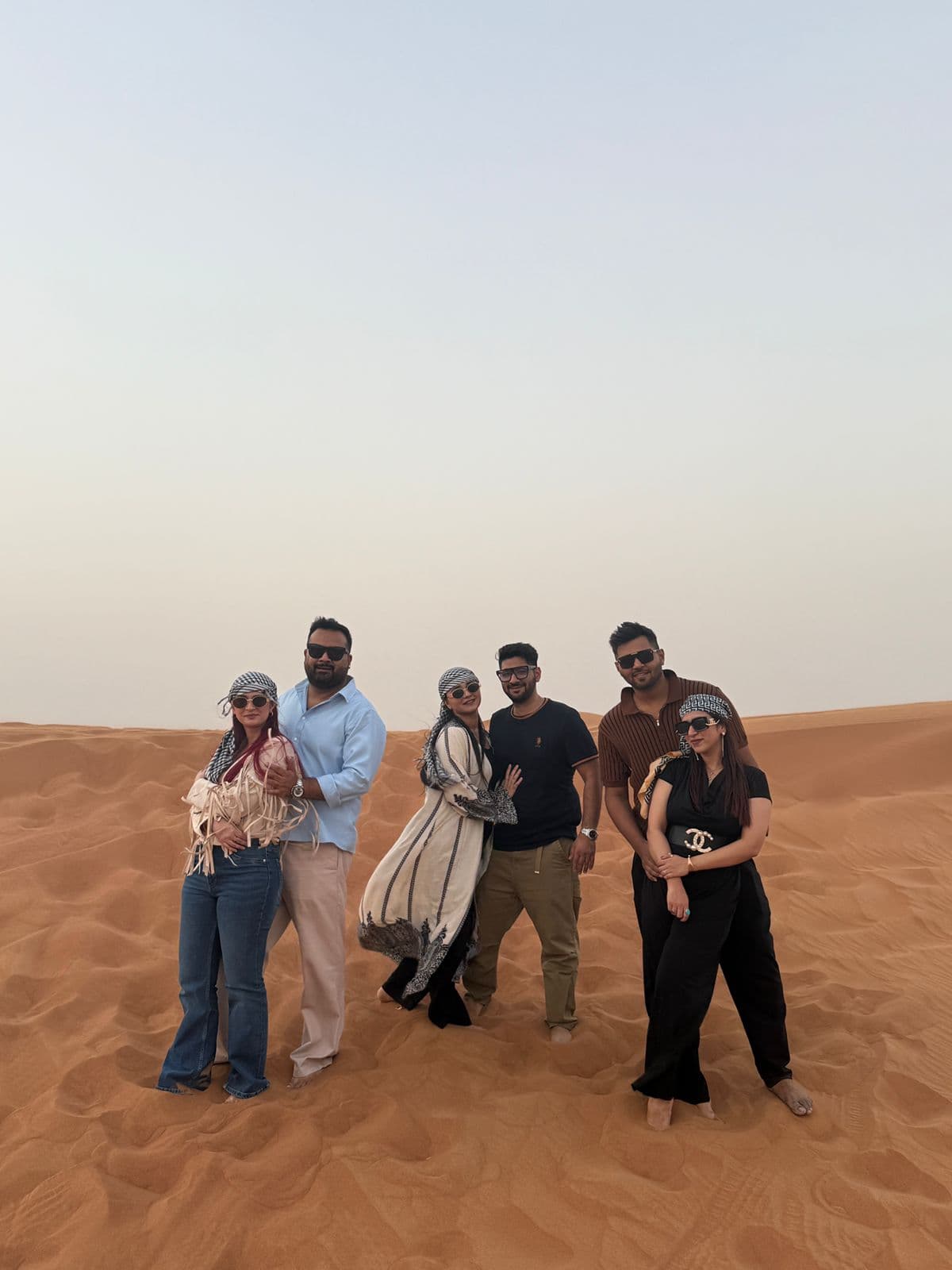 A group of guests posing together among the dunes